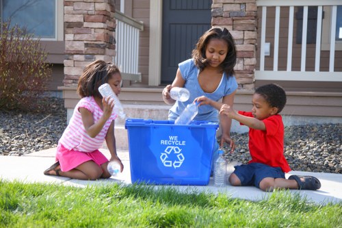 Recycling and composting bins in use